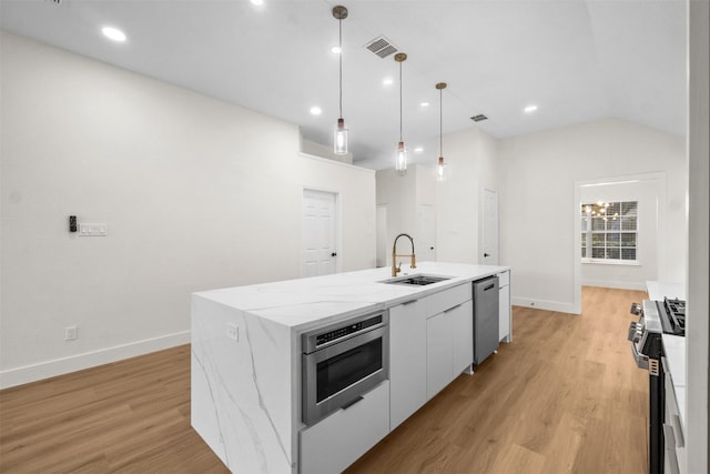 5809 Hidden Pine Ln, Mckinney, TX 75070 - kitchen featuring a sink, stainless steel appliances, baseboards, light wood finished floors, and lofted ceiling