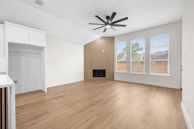 5809 Hidden Pine Ln, Mckinney, TX 75070 - unfurnished living room featuring a ceiling fan, light wood-style flooring, a fireplace, baseboards, and vaulted ceiling
