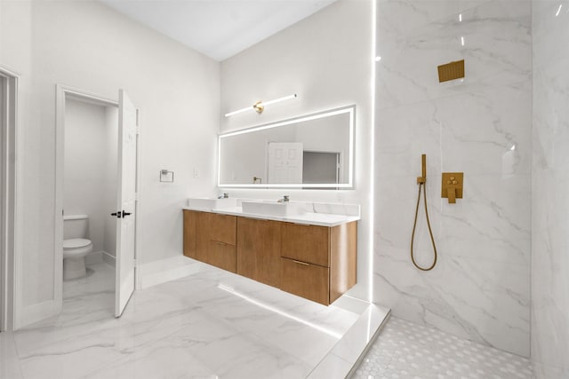 5809 Hidden Pine Ln, Mckinney, TX 75070 - bathroom with toilet, double vanity, a marble finish shower, marble finish flooring, and baseboards