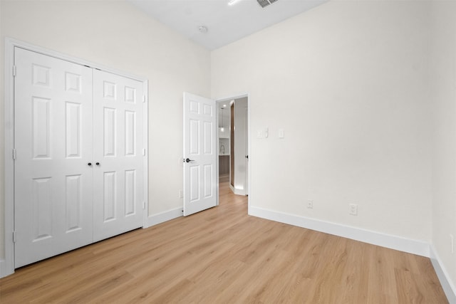 5809 Hidden Pine Ln, Mckinney, TX 75070 - unfurnished bedroom featuring light wood-type flooring, baseboards, and a closet