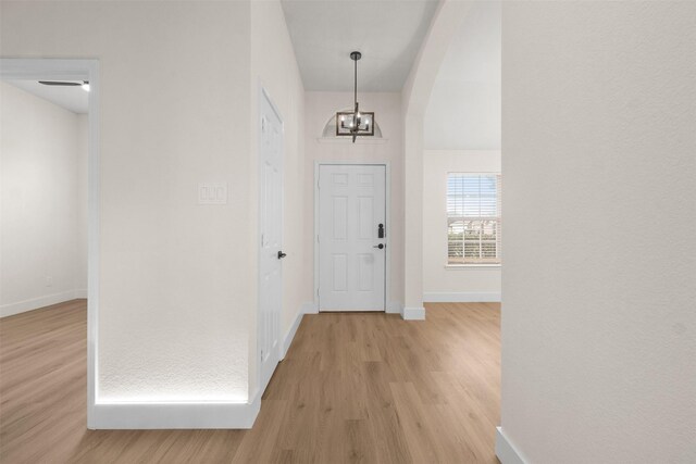5809 Hidden Pine Ln, Mckinney, TX 75070 - foyer entrance featuring light wood-type flooring, baseboards, and a chandelier