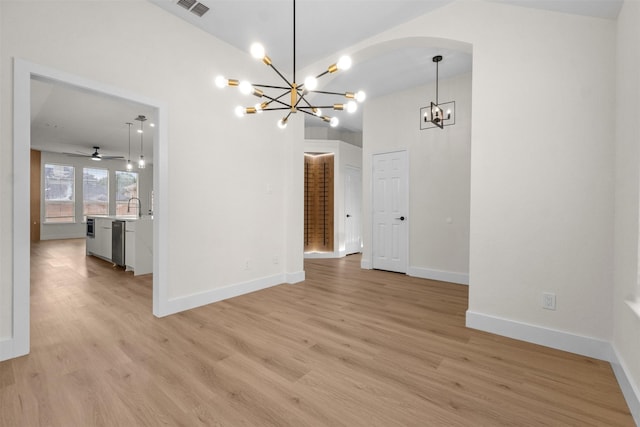 5809 Hidden Pine Ln, Mckinney, TX 75070 - spare room featuring a chandelier, light wood-style flooring, a sink, and arched walkways