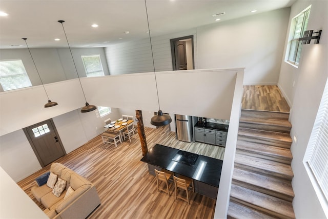 1327 Whispering Springs Dr, Tool, TX 75143 - living room featuring light wood finished floors, recessed lighting, stairs, and a high ceiling