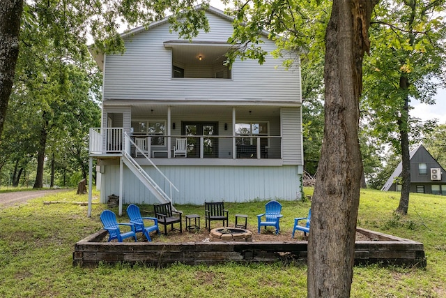 1327 Whispering Springs Dr, Tool, TX 75143 - back of house with a fire pit, stairway, and a lawn