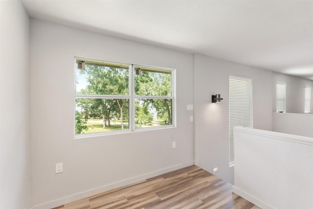 1327 Whispering Springs Dr, Tool, TX 75143 - unfurnished room featuring plenty of natural light, light wood finished floors, and baseboards
