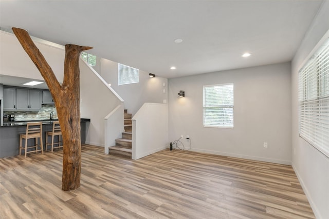 1327 Whispering Springs Dr, Tool, TX 75143 - unfurnished living room featuring light wood-style floors, stairs, baseboards, and recessed lighting