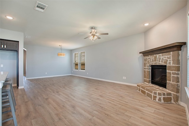 2151 Slow Stream Dr, Royse City, TX 75189 - unfurnished living room with ceiling fan, light wood-style flooring, baseboards, recessed lighting, and a stone fireplace