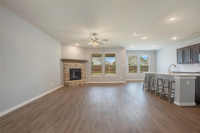2151 Slow Stream Dr, Royse City, TX 75189 - living area featuring ceiling fan, dark wood finished floors, recessed lighting, baseboards, and a fireplace