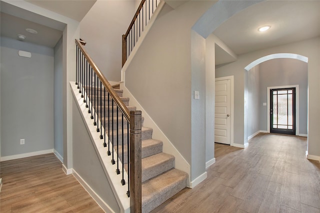 2151 Slow Stream Dr, Royse City, TX 75189 - stairway with arched walkways, wood finished floors, and baseboards
