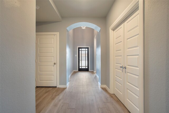 2151 Slow Stream Dr, Royse City, TX 75189 - corridor featuring arched walkways, light wood-style flooring, and baseboards