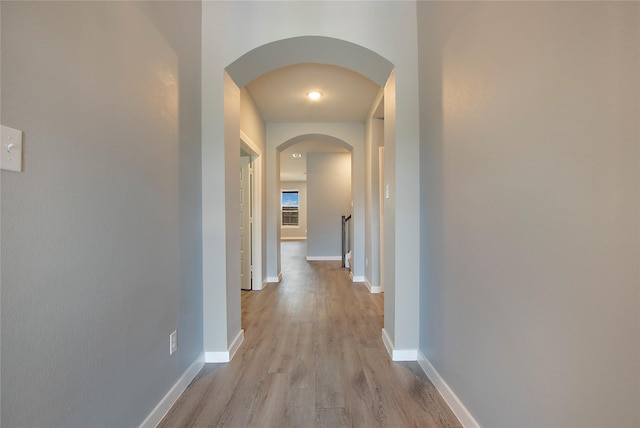 2151 Slow Stream Dr, Royse City, TX 75189 - corridor with arched walkways, light wood finished floors, and baseboards