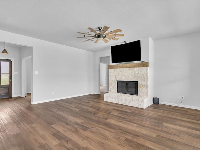 1013 Northern Oaks Ct, Springtown, TX 76082 - unfurnished living room with a ceiling fan, a fireplace, and wood finished floors
