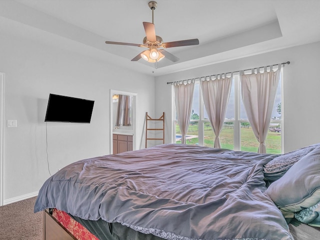 1013 Northern Oaks Ct, Springtown, TX 76082 - bedroom featuring carpet floors, baseboards, a raised ceiling, ceiling fan, and ensuite bath