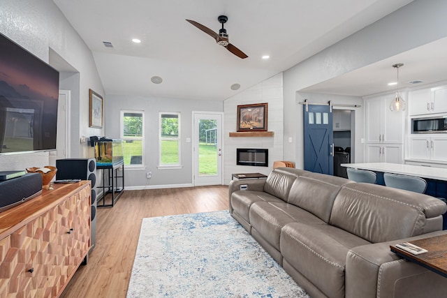200 Settlers Bnd, Lowry Crossing, TX 75069 - living room with vaulted ceiling, a ceiling fan, light wood-style flooring, a barn door, and recessed lighting