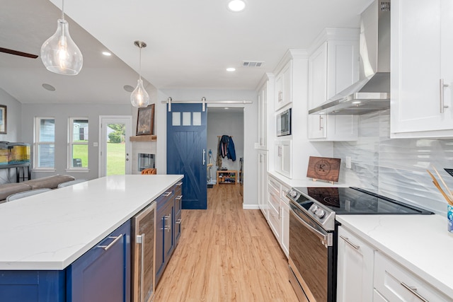200 Settlers Bnd, Lowry Crossing, TX 75069 - kitchen with wall chimney exhaust hood, appliances with stainless steel finishes, blue cabinetry, wine cooler, and light wood finished floors