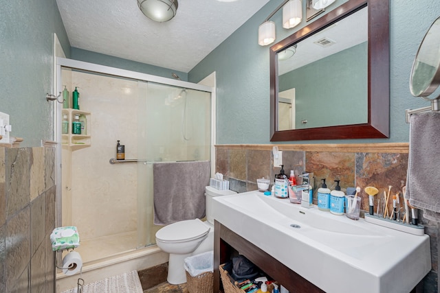 200 Settlers Bnd, Lowry Crossing, TX 75069 - full bath featuring tile walls, toilet, a stall shower, vanity, and a textured wall