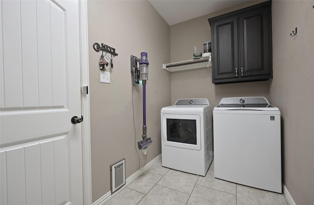 606 Brandt St, Grandview, TX 76050 - washroom featuring separate washer and dryer, cabinet space, light tile patterned floors, and baseboards