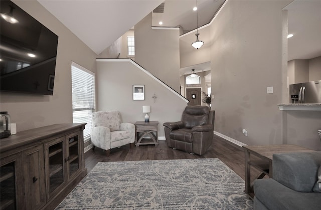 606 Brandt St, Grandview, TX 76050 - living room with wood finished floors, baseboards, a towering ceiling, and stairway
