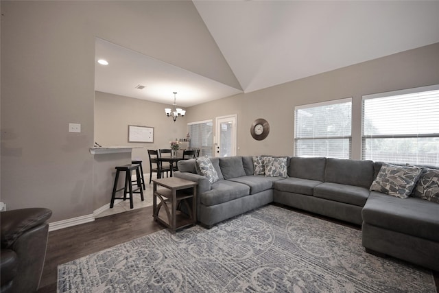 606 Brandt St, Grandview, TX 76050 - living room featuring wood finished floors, a chandelier, healthy amount of natural light, lofted ceiling, and baseboards
