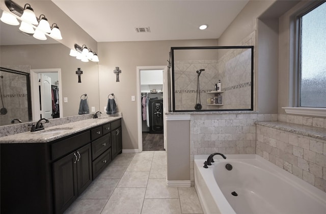 606 Brandt St, Grandview, TX 76050 - full bathroom with a spacious closet, a garden tub, a shower stall, and double vanity