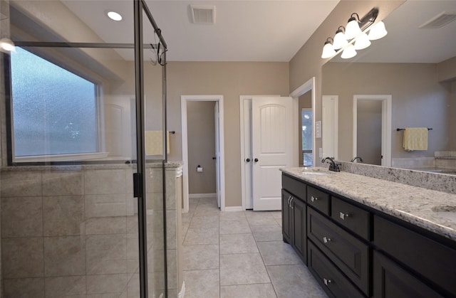 606 Brandt St, Grandview, TX 76050 - bathroom with double vanity, a shower stall, tile patterned floors, and baseboards