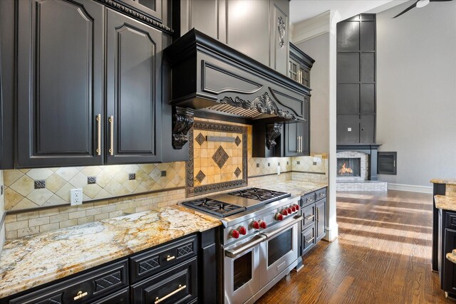 1229 Manchester Dr, Mclendon Chisholm, TX 75032 - kitchen with range with two ovens, dark wood-style flooring, light stone countertops, and backsplash