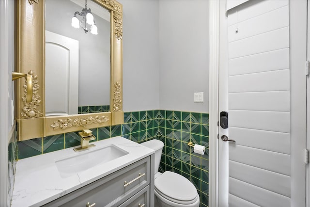 1229 Manchester Dr, Mclendon Chisholm, TX 75032 - bathroom with toilet, vanity, tile walls, and a wainscoted wall
