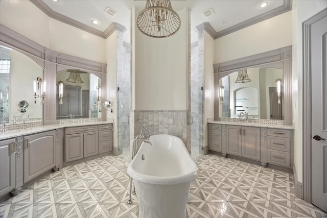 1229 Manchester Dr, Mclendon Chisholm, TX 75032 - full bathroom with ornamental molding, tile walls, a freestanding tub, two vanities, and wainscoting