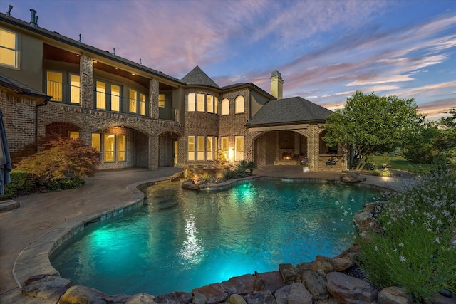 1229 Manchester Dr, Mclendon Chisholm, TX 75032 - pool at dusk with a patio and an outdoor pool