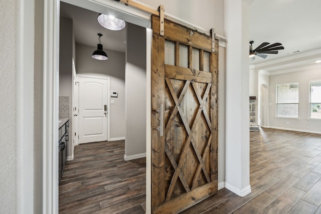 13609 Summer Moon Trl, Ponder, TX 76259 - corridor featuring a barn door, dark wood-style flooring, baseboards, and ornamental molding