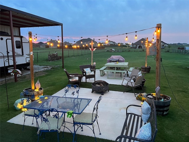 13609 Summer Moon Trl, Ponder, TX 76259 - patio terrace at dusk featuring a fire pit, a patio area, and outdoor dining area