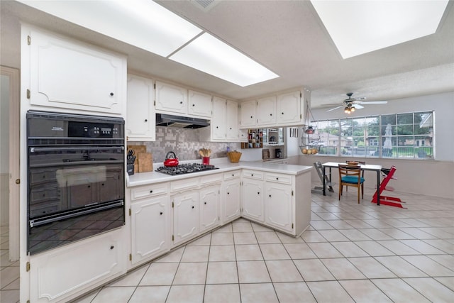 1715 Venetian Cir, Arlington, TX 76013 - kitchen featuring oven, a warming drawer, gas cooktop, under cabinet range hood, and light tile patterned flooring
