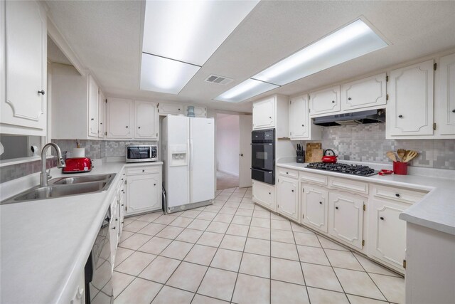 1715 Venetian Cir, Arlington, TX 76013 - kitchen with white fridge with ice dispenser, gas cooktop, stainless steel microwave, under cabinet range hood, and oven