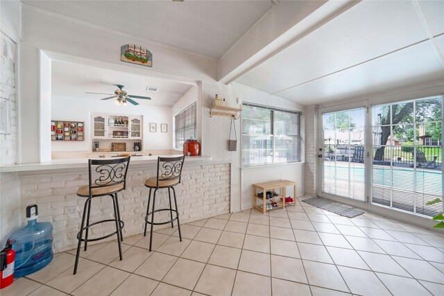 1715 Venetian Cir, Arlington, TX 76013 - kitchen featuring tile patterned floors, ceiling fan, and a kitchen breakfast bar