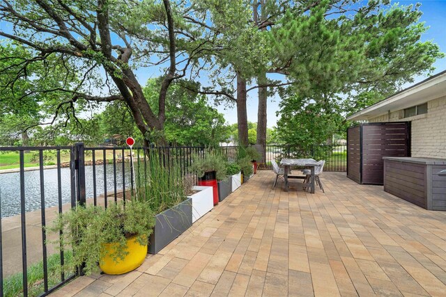1715 Venetian Cir, Arlington, TX 76013 - view of patio with a water view and outdoor dining area