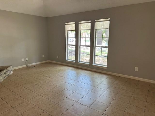1042 Kim Ln, Mesquite, TX 75149 - spare room with light tile patterned floors and baseboards