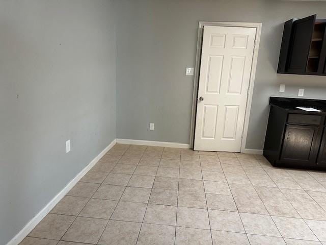 1042 Kim Ln, Mesquite, TX 75149 - unfurnished dining area featuring light tile patterned floors and baseboards