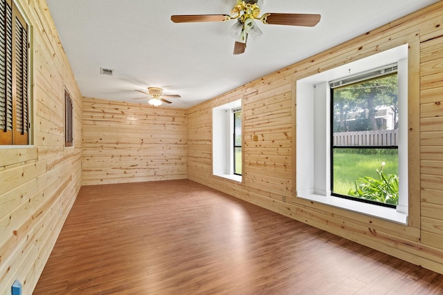 791 Cedar Oak Dr, Pottsboro, TX 75076 - spare room featuring wooden walls, ceiling fan, and wood finished floors