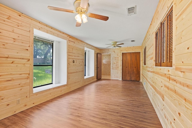 791 Cedar Oak Dr, Pottsboro, TX 75076 - unfurnished room with wood walls, wood finished floors, and a ceiling fan