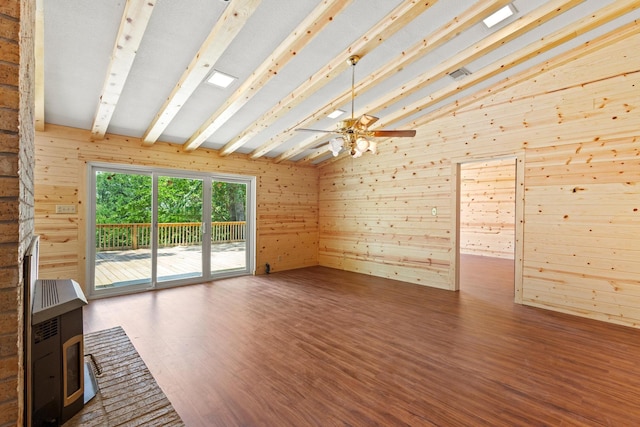791 Cedar Oak Dr, Pottsboro, TX 75076 - unfurnished living room featuring a wood stove, wood finished floors, wood walls, and a ceiling fan