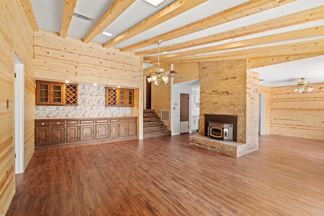 791 Cedar Oak Dr, Pottsboro, TX 75076 - unfurnished living room with ceiling fan, beam ceiling, wood finished floors, wood walls, and stairway