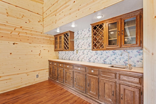 791 Cedar Oak Dr, Pottsboro, TX 75076 - kitchen featuring a sink, brown cabinetry, glass insert cabinets, light countertops, and wood finished floors