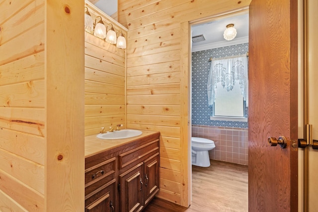 791 Cedar Oak Dr, Pottsboro, TX 75076 - bathroom featuring toilet, vanity, crown molding, wallpapered walls, and wood finished floors