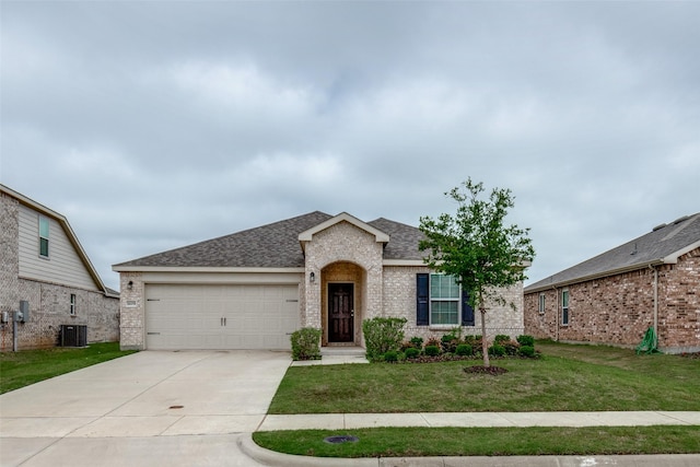 1609 Silas Dr, Forney, TX 75126 - view of front of property featuring an attached garage, brick siding, a front yard, and driveway