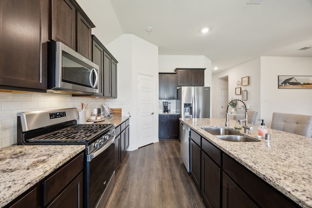 152 Whitetail Way, Caddo Mills, TX 75135 - kitchen featuring appliances with stainless steel finishes, a sink, dark wood-style flooring, light stone counters, and tasteful backsplash
