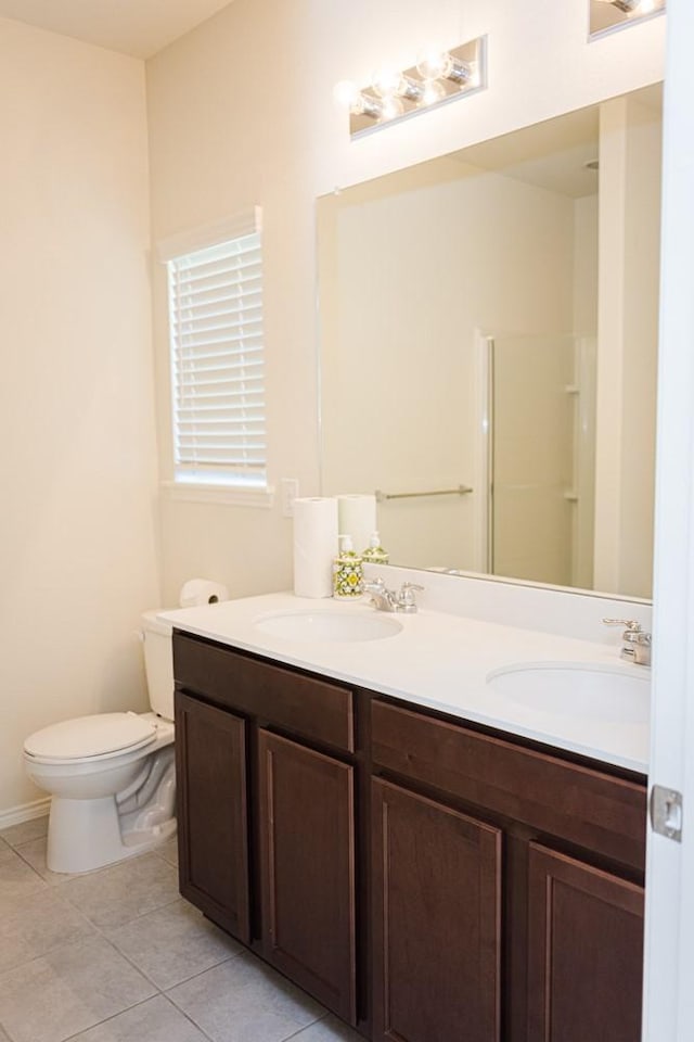 2225 Bernese Ln, Fort Worth, TX 76131 - bathroom featuring double vanity, tile patterned flooring, toilet, and a shower