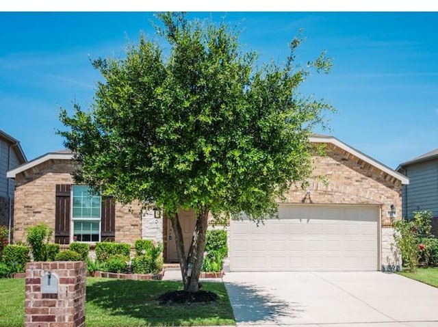2225 Bernese Ln, Fort Worth, TX 76131 - obstructed view of property featuring driveway, an attached garage, stone siding, and a front yard