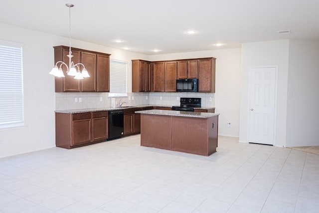 2225 Bernese Ln, Fort Worth, TX 76131 - kitchen with black appliances, a chandelier, tasteful backsplash, light stone countertops, and a sink