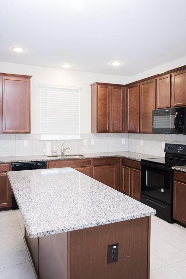 2225 Bernese Ln, Fort Worth, TX 76131 - kitchen featuring black appliances, a sink, light tile patterned floors, a center island, and backsplash