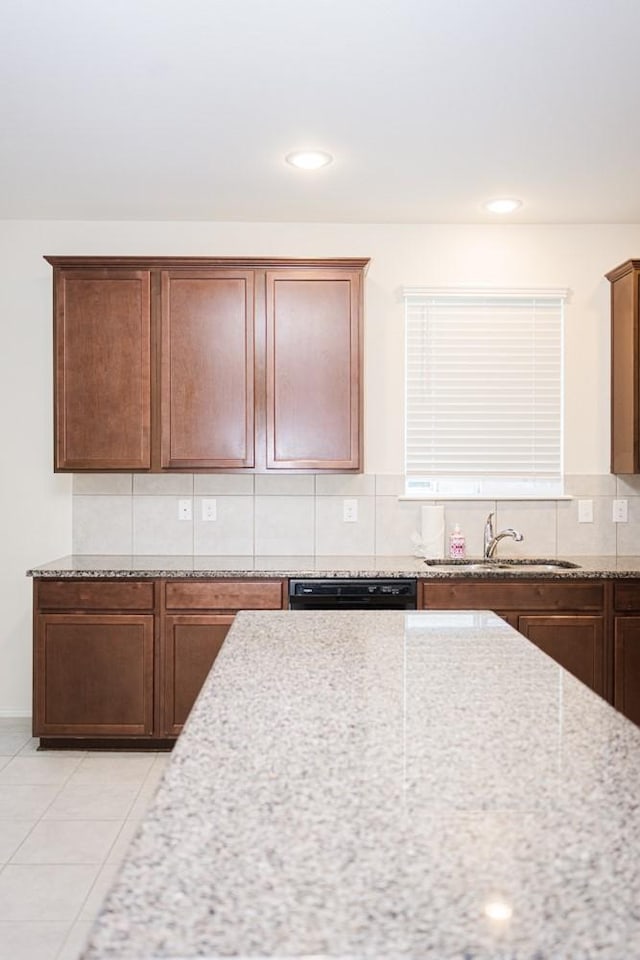 2225 Bernese Ln, Fort Worth, TX 76131 - kitchen featuring a sink, dishwasher, decorative backsplash, light stone countertops, and light tile patterned floors